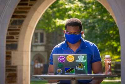 Student with mask on a laptop